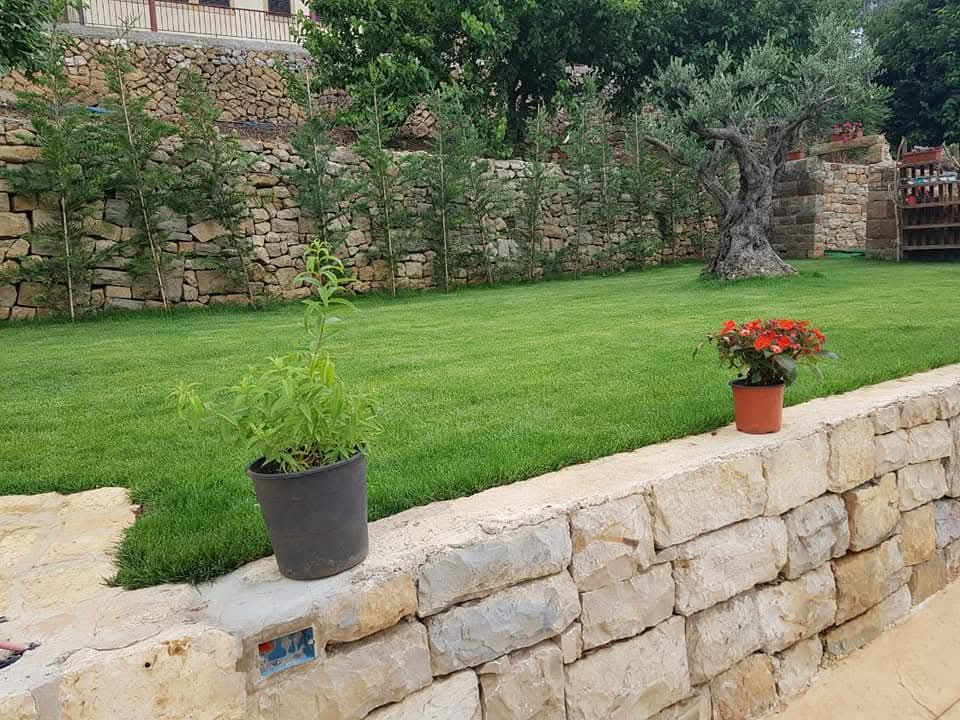 After: terraced lawn with dry-stone wall