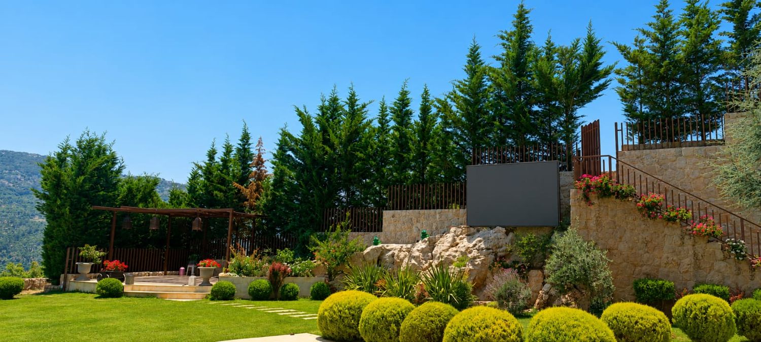 Terraced garden with stone walls, cypress trees and pergola
